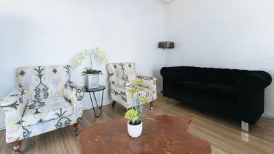 a living room with two chairs and a couch at RedDoorz near SM Calamba in Laguna