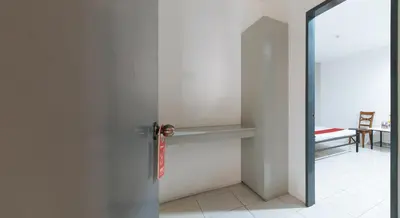 a door to a room with a table and a chair at RedDoorz near SM Calamba in Laguna