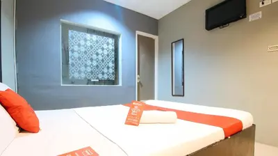 a room with two beds and a tv on the wall at RedDoorz @ P Florentino Street Sampaloc Manila in Manila