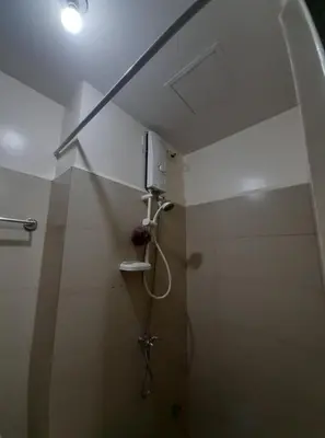 a shower in a bathroom with a ceiling at Green Residence 23rd Floor in Manila