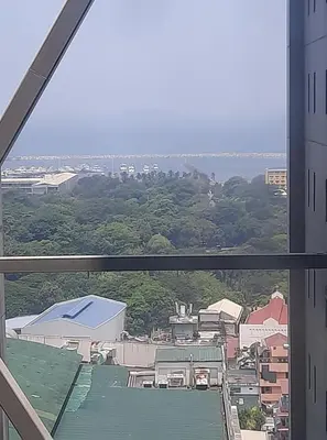 a view of a city from a window at Green Residence 23rd Floor in Manila