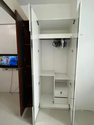 a room with white shelves and a tv at 1BR Jazz Bel-air Makati, POOLVIEW, TRIDENT in Manila