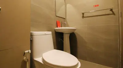 a bathroom with a white toilet and a sink at RedDoorz Plus @ San Marcelino Malate in Manila