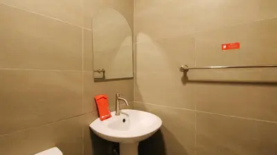 a bathroom with a white sink and a shower at RedDoorz Plus @ San Marcelino Malate in Manila