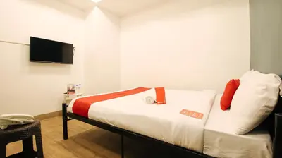 a bedroom with a bed with a tv on the wall at RedDoorz Plus @ San Marcelino Malate in Manila