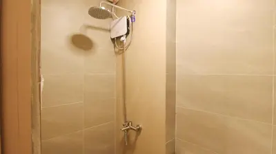 a shower with a glass door in a bathroom at RedDoorz Plus @ San Marcelino Malate in Manila