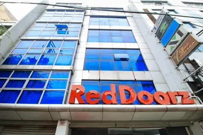 a red door sign on the side of a building at RedDoorz Plus @ San Marcelino Malate in Manila