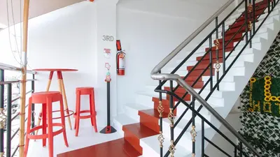 a staircase with red stools in a house at RedDoorz near Mercado del Lago in Manila