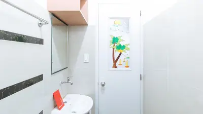 a bathroom with a shower and a toilet and a sink at RedDoorz at CAA Road Las Pinas in Manila