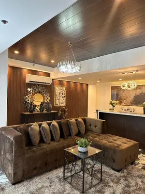 a living room with a brown couch and a table at City View at MAKATI Prime Luxury in Manila