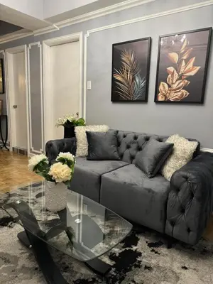 a living room with a couch and a glass table at City View at MAKATI Prime Luxury in Manila