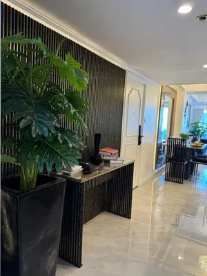a living room with a desk and a plant at City View at MAKATI Prime Luxury in Manila