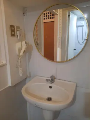 a bathroom with a sink and a mirror at Airport Hostel Manila in Manila