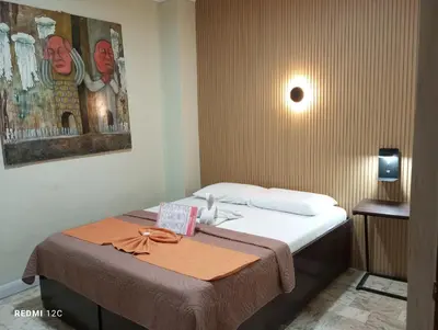 a hotel room with a bed with a ribbon on it at Airport Hostel Manila in Manila