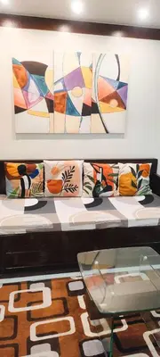 a display of pillows on a couch with a glass table at Centropolis King Bed Deluxe in Manila