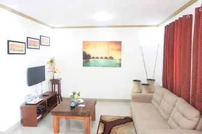 a living room with a couch and a table at Patricios Apartelle Taguig in Manila