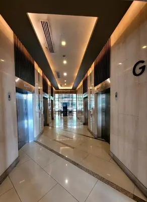 a hallway of a building with elevators in it at Andy's Place One Eastwood Tower 1 in Manila
