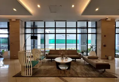 a living room with a couch and a table at Andy's Place One Eastwood Tower 1 in Manila