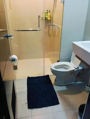 a bathroom with a shower and a toilet and a sink at 81 Newport Boulevard Cluster 4 - 8F across NAIA Airport, Terminal 3 in Manila