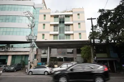 a car driving in front of a building at Festive Hotel Makati in Manila