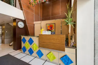 a lobby with a clock on the wall at Festive Hotel Makati in Manila