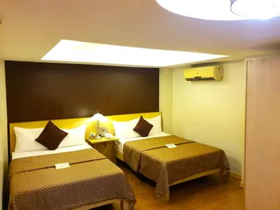 a hotel room with two beds in a room at Festive Hotel Makati in Manila