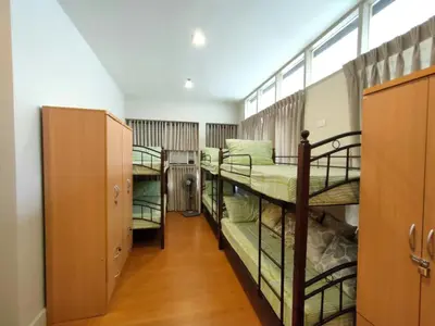 a room with three bunk beds and a hallway at 538 Dormitel in Manila
