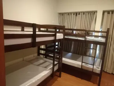 a room with three bunk beds in a room at 538 Dormitel in Manila