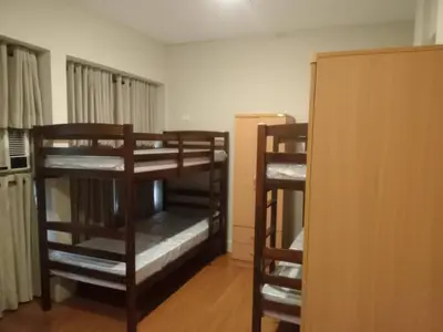 a room with two bunk beds and a closet at 538 Dormitel in Manila