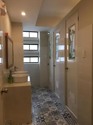 a large bathroom with a sink and a mirror at 538 Dormitel in Manila