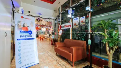 a store with a chair in front of a store at RedDoorz at The Providence Tower in Manila