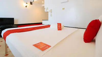 a room with a bed with a sign on it at RedDoorz at The Providence Tower in Manila