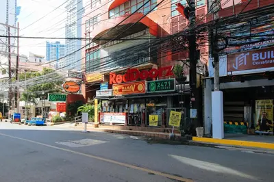 a street with a store on the side of a building at RedDoorz at The Providence Tower in Manila