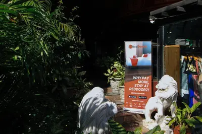 two white statues sitting in front of a sign at RedDoorz at The Providence Tower in Manila
