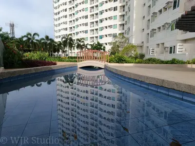 a pool of water in front of a building at Choco Condotel- Anuva Prime 1 Couple Suite Lakeview in Manila