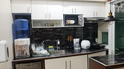a kitchen counter with a sink and a microwave at Choco Condotel- Anuva Prime 1 Couple Suite Lakeview in Manila