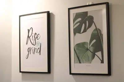 two framed pictures on a wall with the words life grind at A2J Luxury BGC Balcony Suite Near SM AURA Taguig in Manila