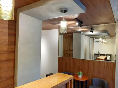 a dining room with a table and a mirror at Anex Hotel in Manila