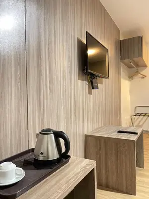 a tea kettle on a counter in a room at Anex Hotel in Manila