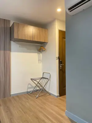 a kitchen with a chair in a room at Anex Hotel in Manila