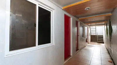 a hallway with a large window in a house at RedDoorz near Christ the King Medical Center in Manila