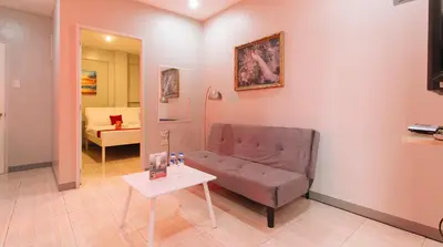 a living room with a couch and a table at RedDoorz near Christ the King Medical Center in Manila