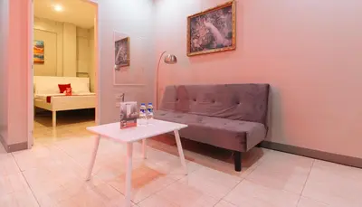 a living room with a couch and a table at RedDoorz near Christ the King Medical Center in Manila