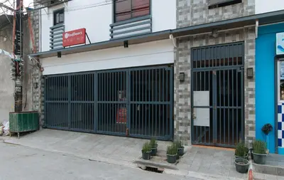 a store front with black gates on a building at RedDoorz near Christ the King Medical Center in Manila