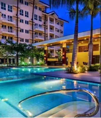 a swimming pool in front of a building at The Rochester in Manila