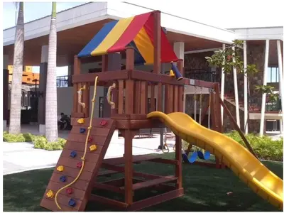 a wooden playground with a slide and a slideintend at The Rochester in Manila
