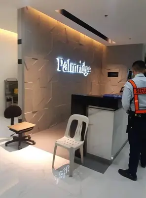 a man standing in front of a counter with a chair at The Rochester in Manila