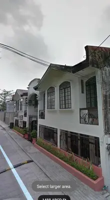 a house on a street next to a street larger area at Grand Traveler Suite Inc in Manila