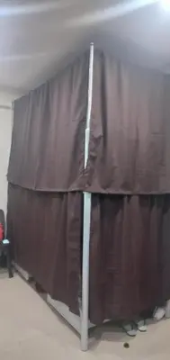 a curtain in a room with people standing behind it at Snoozeph in Manila