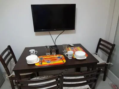 a table with a tray of food and a television at manila sea view homes 21 in Manila